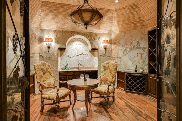 12861 Hughes Park Rd, Austin, TX 78732 - wine area featuring brick ceiling and wood finished floors