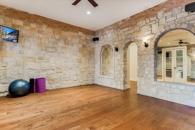 12861 Hughes Park Rd, Austin, TX 78732 - unfurnished room with a ceiling fan, arched walkways, and wood finished floors