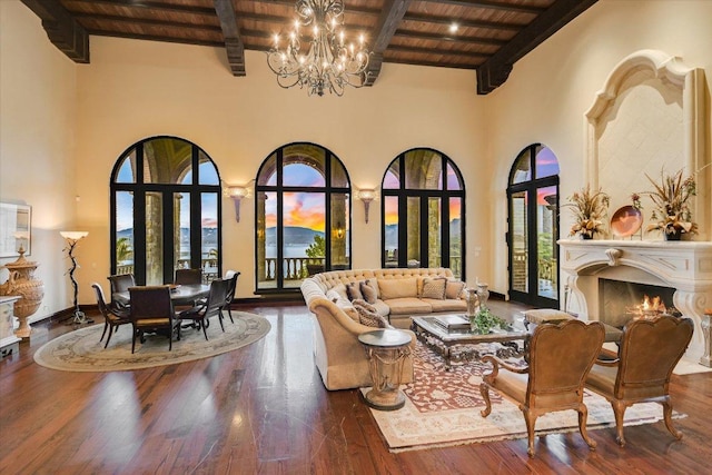 12861 Hughes Park Rd, Austin, TX 78732 - living area featuring wood ceiling, a chandelier, beamed ceiling, a high ceiling, and wood-type flooring