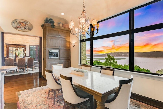 12861 Hughes Park Rd, Austin, TX 78732 - dining space featuring a chandelier and dark wood-type flooring