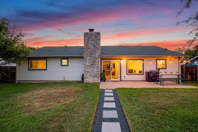 8907 Hunters Trce, Austin, TX 78758 - back of property featuring a patio, a chimney, and a shingled roof