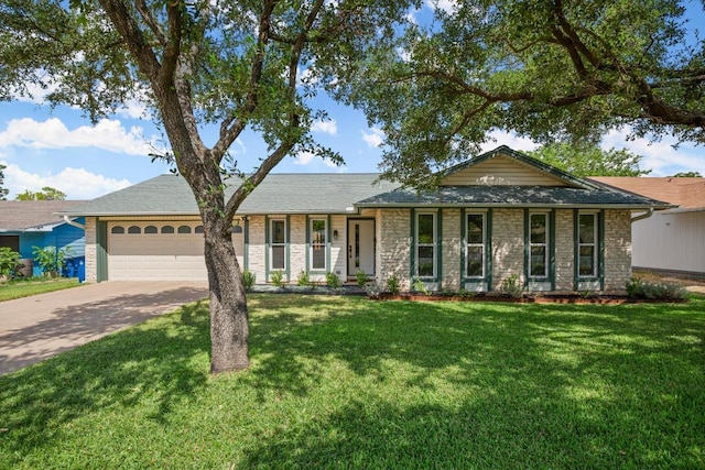 8907 Hunters Trce, Austin, TX 78758 - ranch-style house featuring an attached garage, stone siding, concrete driveway, and a front yard