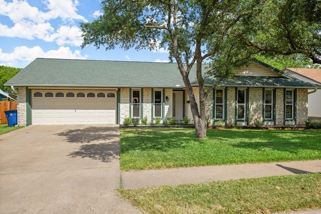 8907 Hunters Trce, Austin, TX 78758 - single story home with stone siding, driveway, a garage, a front yard, and roof with shingles