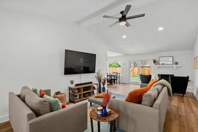 8907 Hunters Trce, Austin, TX 78758 - living area with wood finished floors, a large fireplace, a ceiling fan, recessed lighting, and baseboards