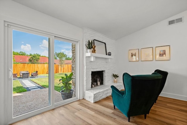 8907 Hunters Trce, Austin, TX 78758 - sitting room with lofted ceiling, wood finished floors, a large fireplace, and baseboards