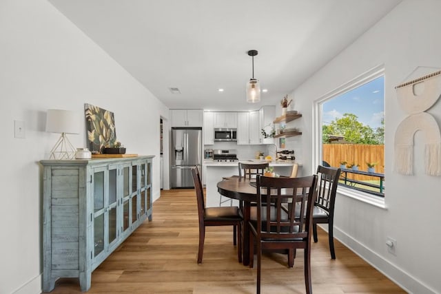 8907 Hunters Trce, Austin, TX 78758 - dining area featuring baseboards, light wood finished floors, and recessed lighting