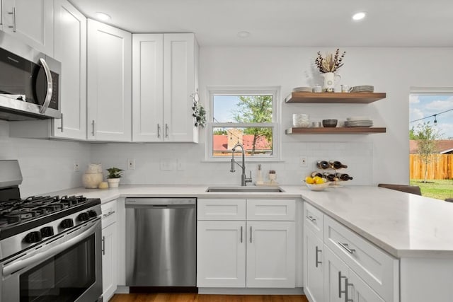 8907 Hunters Trce, Austin, TX 78758 - kitchen with appliances with stainless steel finishes, a sink, light countertops, plenty of natural light, and recessed lighting