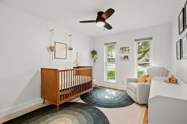 8907 Hunters Trce, Austin, TX 78758 - bedroom with baseboards, a nursery area, and ceiling fan