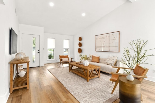 8907 Hunters Trce, Austin, TX 78758 - living room featuring vaulted ceiling, light wood-style floors, and recessed lighting