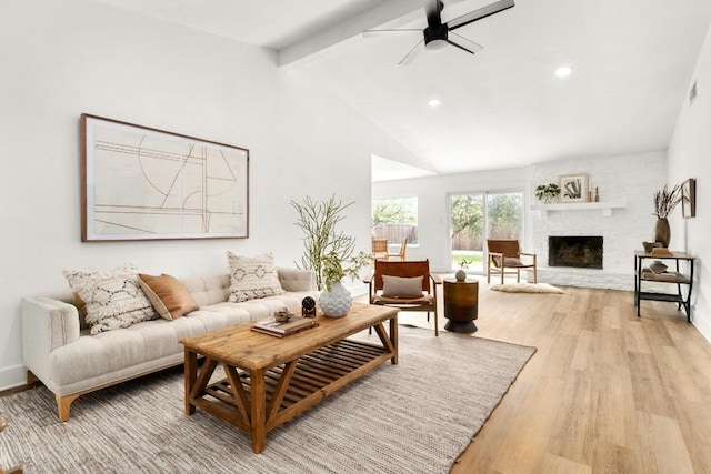 8907 Hunters Trce, Austin, TX 78758 - living room with beam ceiling, light wood-style flooring, a ceiling fan, recessed lighting, and a fireplace