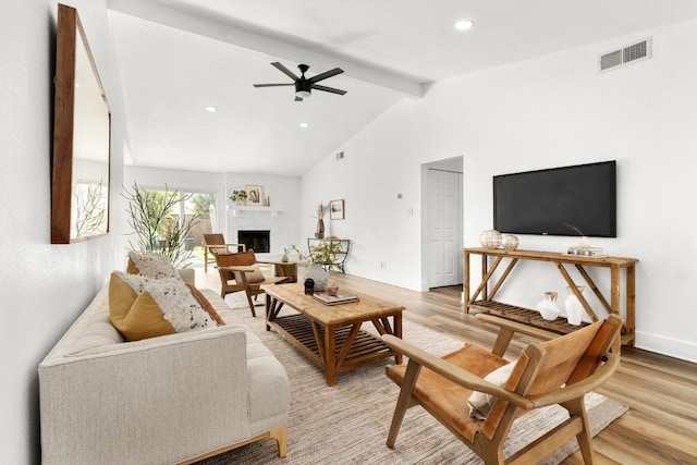 8907 Hunters Trce, Austin, TX 78758 - living room with light wood-type flooring, a large fireplace, a ceiling fan, and recessed lighting