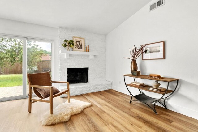 8907 Hunters Trce, Austin, TX 78758 - sitting room with light wood-style floors and a fireplace