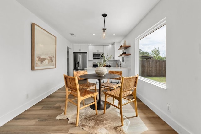 8907 Hunters Trce, Austin, TX 78758 - dining space featuring wood finished floors and recessed lighting