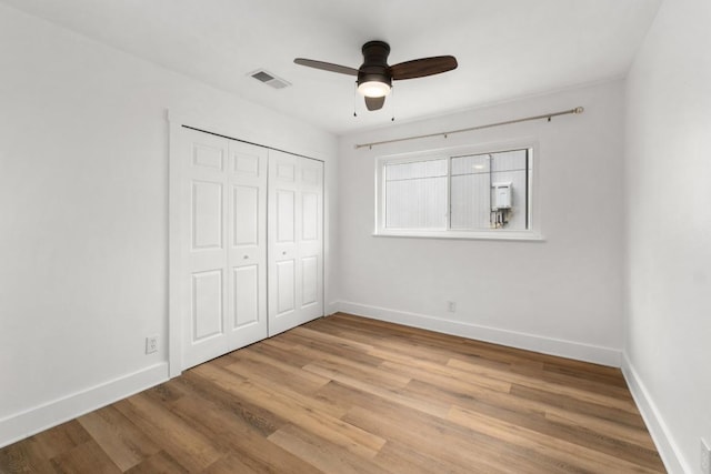 8907 Hunters Trce, Austin, TX 78758 - unfurnished bedroom featuring a closet, wood finished floors, and a ceiling fan