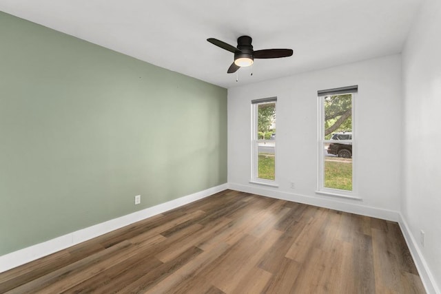 8907 Hunters Trce, Austin, TX 78758 - spare room featuring wood finished floors and a ceiling fan