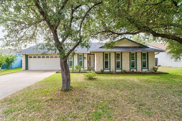 8907 Hunters Trce, Austin, TX 78758 - ranch-style home with an attached garage, concrete driveway, a front yard, and stone siding