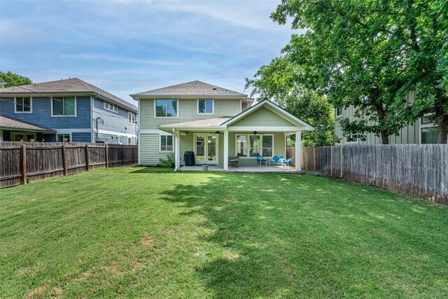 705 E 49th St Unit A, Austin, TX 78751 - back of property with a ceiling fan, a patio, and a fenced backyard