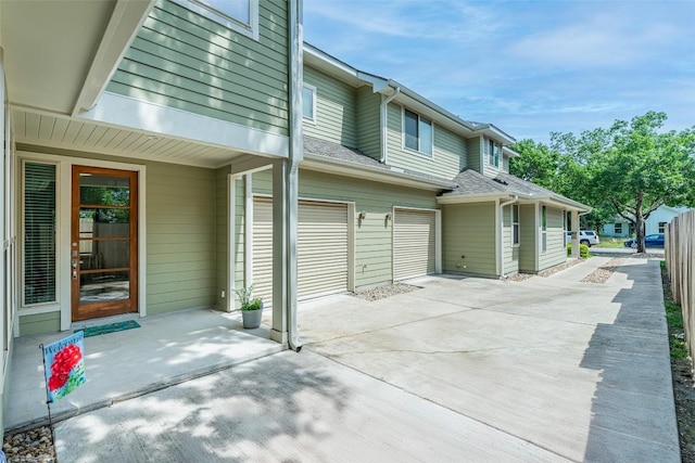 705 E 49th St Unit A, Austin, TX 78751 - view of patio / terrace featuring an attached garage and concrete driveway