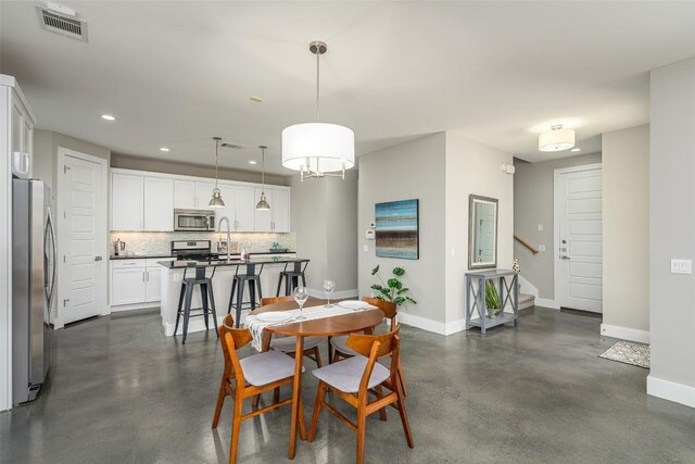 705 E 49th St Unit A, Austin, TX 78751 - dining room featuring concrete flooring, recessed lighting, and stairs