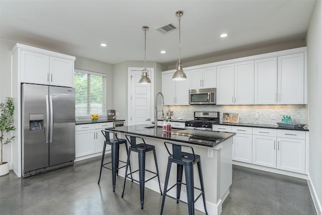 705 E 49th St Unit A, Austin, TX 78751 - kitchen with stainless steel appliances, finished concrete flooring, tasteful backsplash, white cabinetry, and recessed lighting