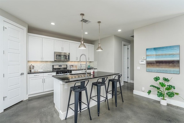 705 E 49th St Unit A, Austin, TX 78751 - kitchen with appliances with stainless steel finishes, backsplash, recessed lighting, a kitchen bar, and white cabinets
