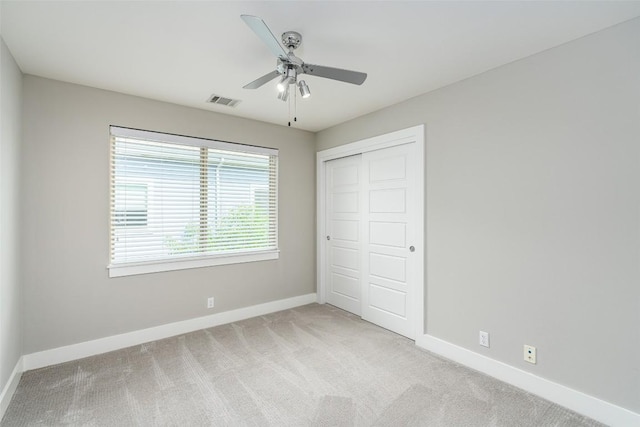705 E 49th St Unit A, Austin, TX 78751 - unfurnished bedroom with light carpet, a closet, and ceiling fan