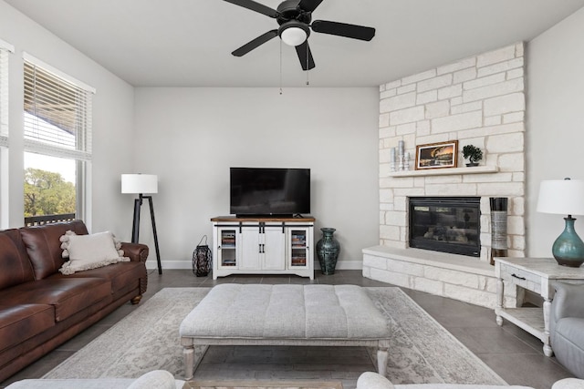 138 Prism Cv, Dripping Springs, TX 78620 - living area with ceiling fan, tile patterned floors, a fireplace, and baseboards