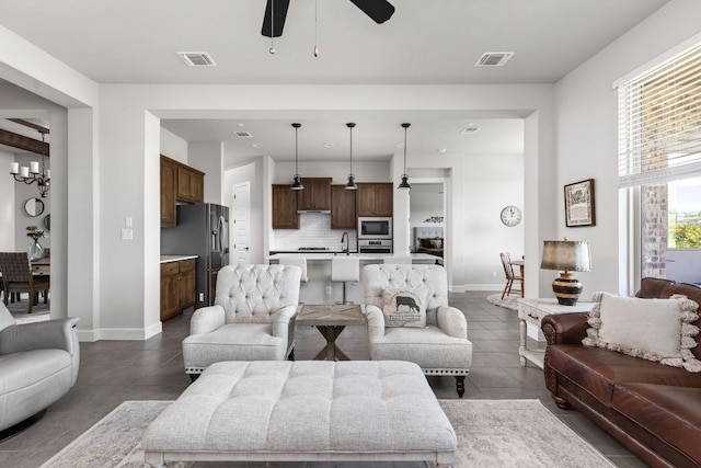 138 Prism Cv, Dripping Springs, TX 78620 - living room featuring dark tile patterned floors, a ceiling fan, and baseboards
