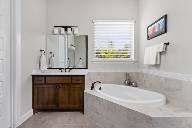138 Prism Cv, Dripping Springs, TX 78620 - bathroom featuring a garden tub, vanity, and tile patterned floors