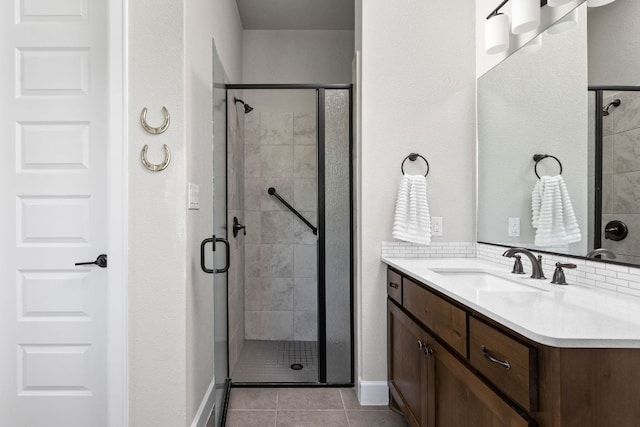 138 Prism Cv, Dripping Springs, TX 78620 - full bathroom with a stall shower, vanity, tile patterned floors, and baseboards