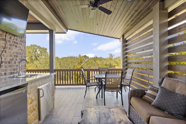 138 Prism Cv, Dripping Springs, TX 78620 - deck with a sink, outdoor dining space, a ceiling fan, and a patio
