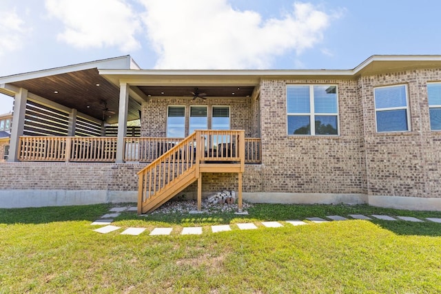 138 Prism Cv, Dripping Springs, TX 78620 - rear view of house featuring a ceiling fan, a yard, brick siding, and stairway