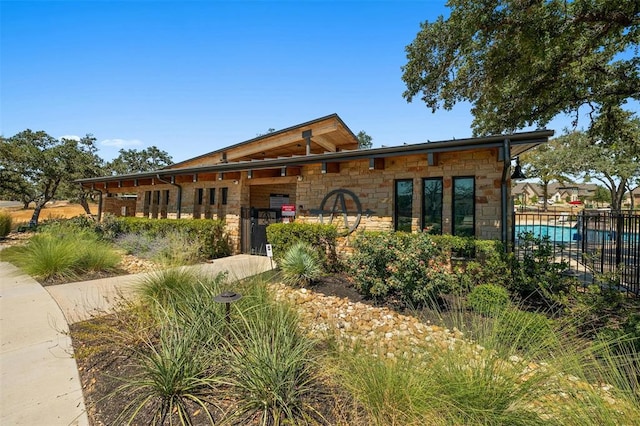 138 Prism Cv, Dripping Springs, TX 78620 - view of front of property featuring fence and stone siding