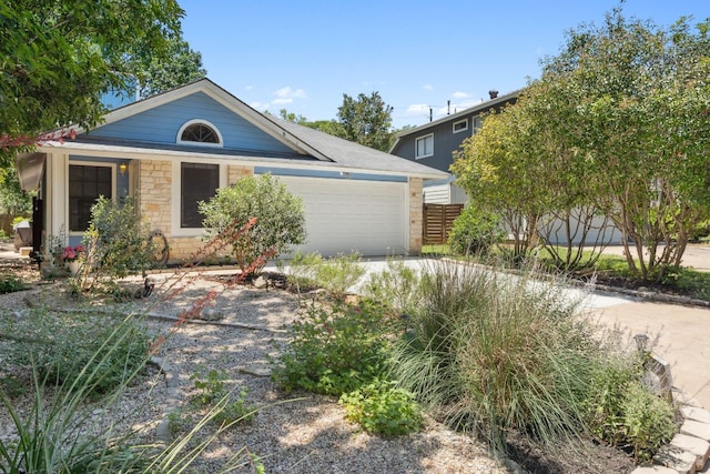 10730 N Platt River Dr, Austin, TX 78748 - view of front of property with an attached garage, stone siding, and driveway