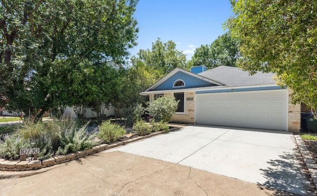 10730 N Platt River Dr, Austin, TX 78748 - view of front of home featuring driveway, a garage, and stone siding
