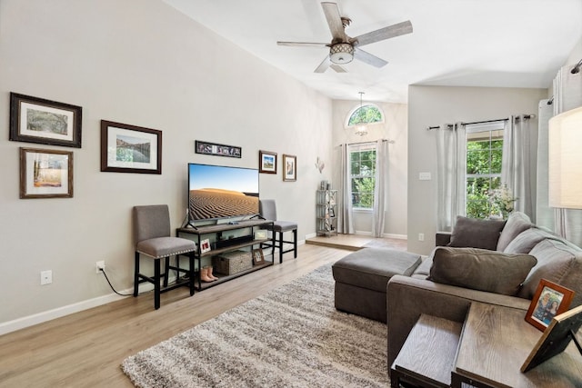 10730 N Platt River Dr, Austin, TX 78748 - living room featuring baseboards, light wood-type flooring, a ceiling fan, and high vaulted ceiling