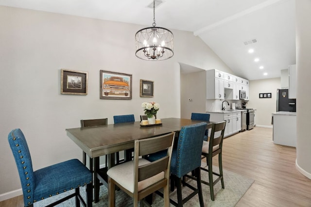 10730 N Platt River Dr, Austin, TX 78748 - dining space featuring light wood-style flooring, baseboards, a chandelier, and high vaulted ceiling