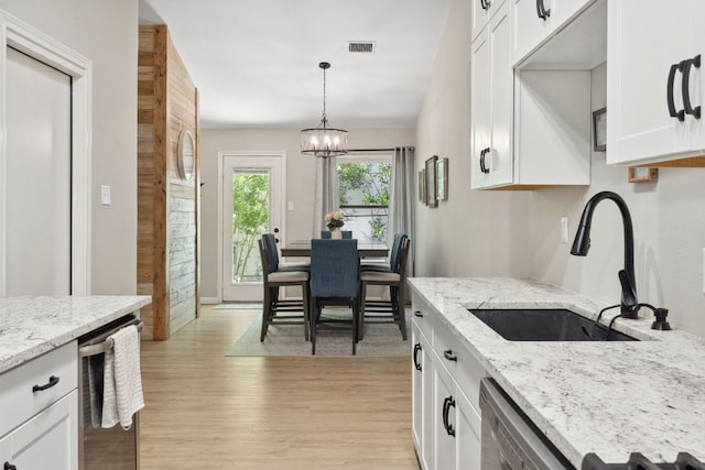 10730 N Platt River Dr, Austin, TX 78748 - kitchen with a sink, light wood finished floors, dishwasher, and white cabinets