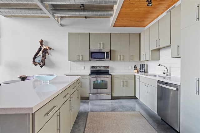 1401 Eva St Unit 406, Austin, TX 78704 - kitchen featuring appliances with stainless steel finishes, gray cabinetry, concrete flooring, a sink, and light countertops