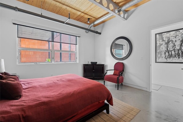 1401 Eva St Unit 406, Austin, TX 78704 - bedroom with finished concrete flooring, baseboards, and wood ceiling with exposed beams