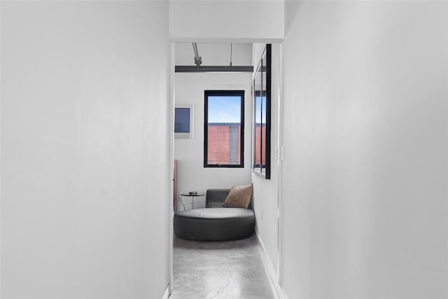 1401 Eva St Unit 406, Austin, TX 78704 - corridor featuring concrete flooring, attic access, and baseboards