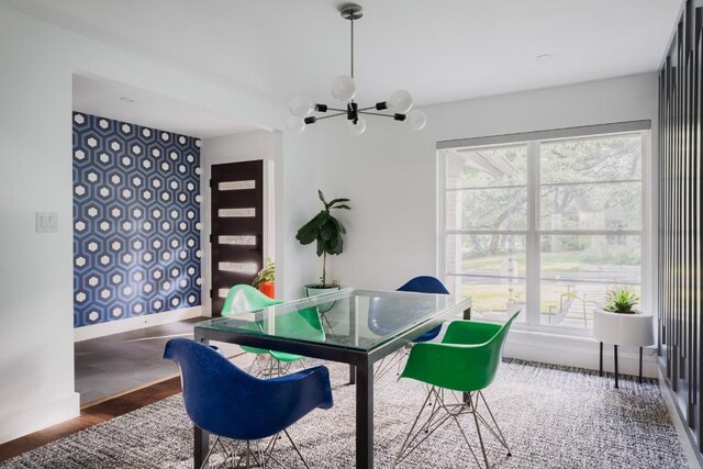 9421 Spring Hollow Dr, Austin, TX 78750 - dining area with a chandelier, baseboards, and wood finished floors