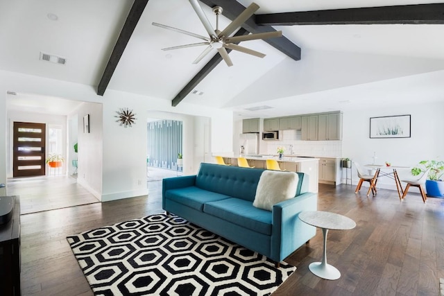 9421 Spring Hollow Dr, Austin, TX 78750 - living room with beamed ceiling, ceiling fan, wood finished floors, baseboards, and high vaulted ceiling