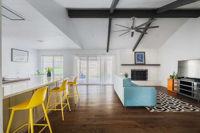 9421 Spring Hollow Dr, Austin, TX 78750 - living area featuring wood finished floors, a ceiling fan, and a brick fireplace