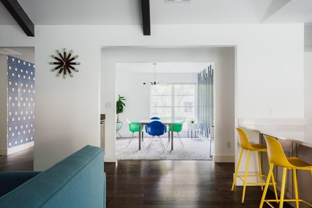 9421 Spring Hollow Dr, Austin, TX 78750 - dining room featuring beamed ceiling, wood finished floors, and baseboards