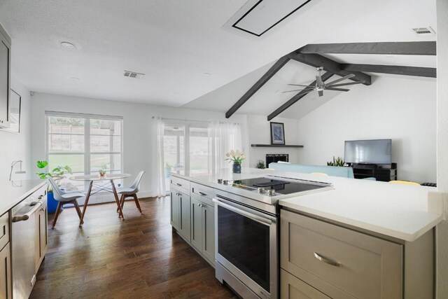 9421 Spring Hollow Dr, Austin, TX 78750 - kitchen featuring stainless steel range with electric cooktop, light countertops, dark wood-type flooring, and open floor plan