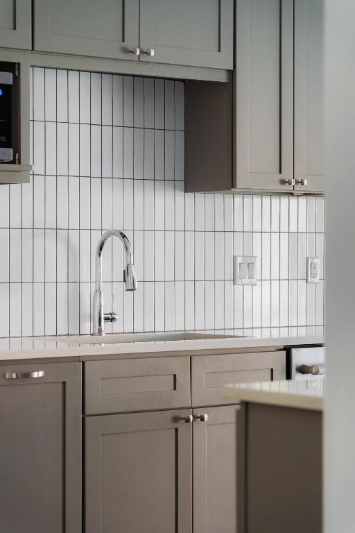 9421 Spring Hollow Dr, Austin, TX 78750 - kitchen featuring dishwashing machine and tasteful backsplash