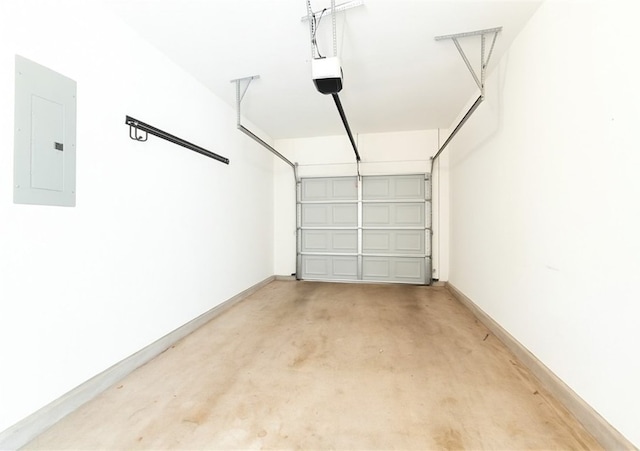 garage featuring electric panel, a garage door opener, and baseboards