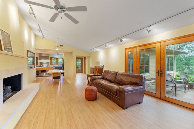 2507 Inwood Pl, Austin, TX 78703 - living area featuring track lighting, french doors, ceiling fan, wood finished floors, and vaulted ceiling