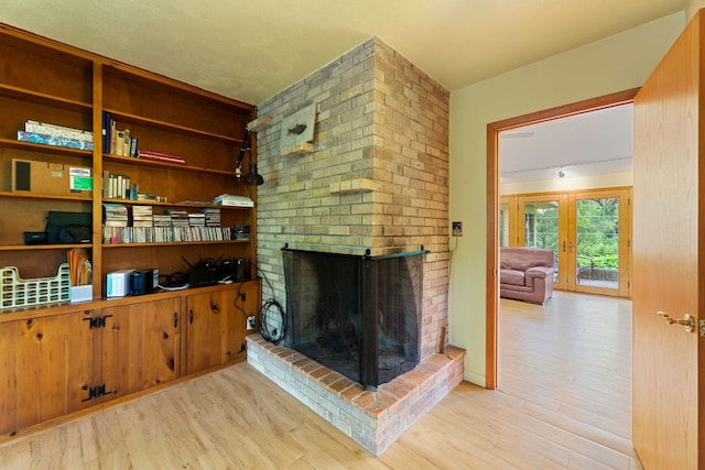 2507 Inwood Pl, Austin, TX 78703 - living area with wood finished floors, a brick fireplace, and french doors